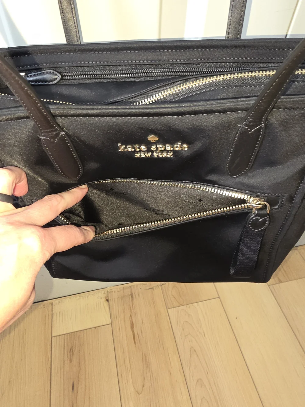 kate spade black tote with gold-tone logo and zipper